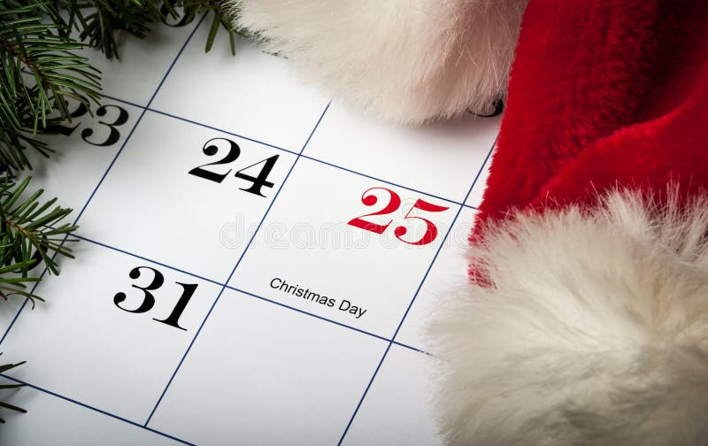 Santa hat laying on a Christmas calendar stock photo Santa hat laying on a Christmas calendar stock photo