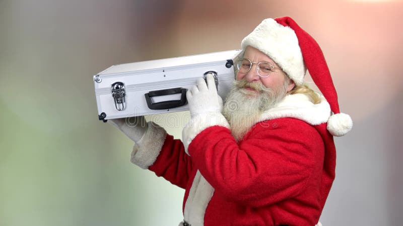 Santa holding case with cash for Christmas.