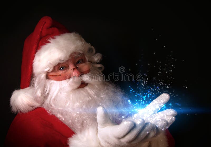 Tema natale con Santa holding luci magiche nelle mani.