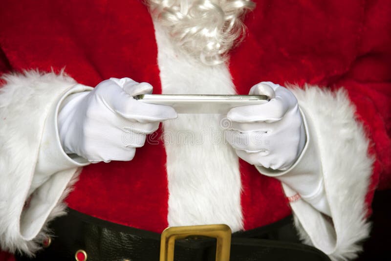 Santa Klaus z listą na iPad obrazy stock Santa Klaus z listą na iPad obrazy stock