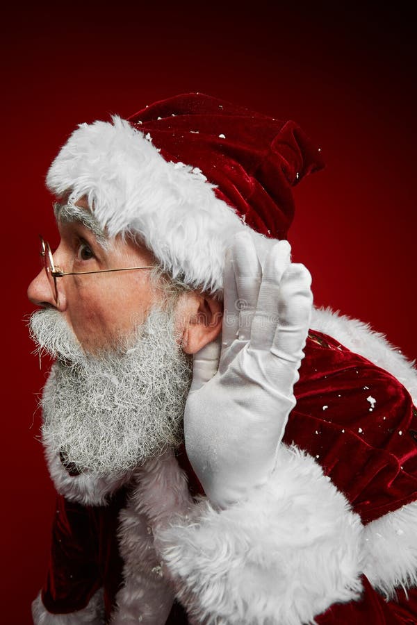 santa-listening-to-secrets-portrait-classic-claus-putting-hand-ear-trying-hear-whisper-standing-against-red-background-163542397.jpg