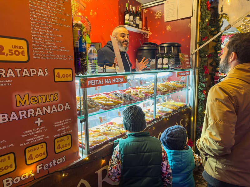 Santa Maria da Feira, Portugal - december 2 2023. Children window shopping on traditional Perlim Christmas market in Santa Maria da Feira, Portugal on winter day. Kids buying candy and french toast in confectionery. Boy choosing sweets in Xmas bakery. Santa Maria da Feira, Portugal - december 2 2023. Children window shopping on traditional Perlim Christmas market in Santa Maria da Feira, Portugal on winter day. Kids buying candy and french toast in confectionery. Boy choosing sweets in Xmas bakery