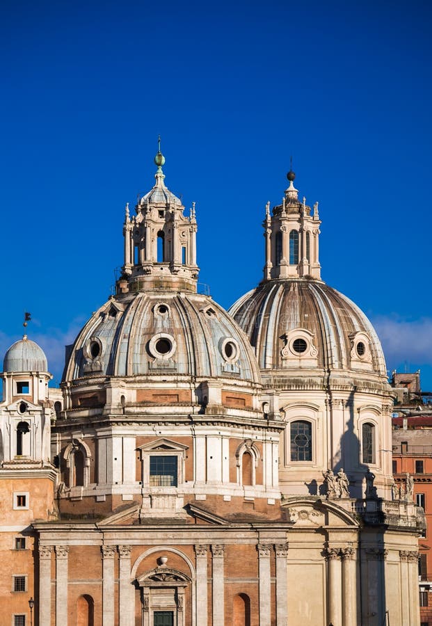 Photograph of Santa Maria di Loreto, Santissimo Nome di Maria and the shadow of Colonna Traiana in Rome, Italy.