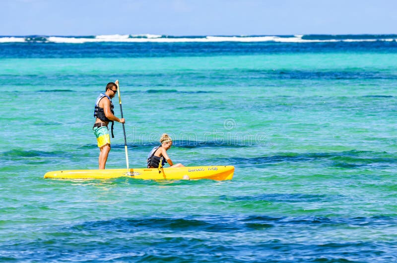 SANTO DOMINGO, DOMINICAN REPUBLIC - OCTOBER 29, 2015: Couple kayaking in ocean