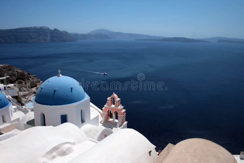 Famous greek island church over aegean mediterranean sea santorini greece with cruise ship in distance. Famous greek island church over aegean mediterranean sea santorini greece with cruise ship in distance