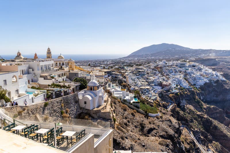 Santorini, Greece - October 15, 2024: Panoramic View of Santorini's Hillside: Whitewashed Buildings and Azure Aegean Waters stock photo