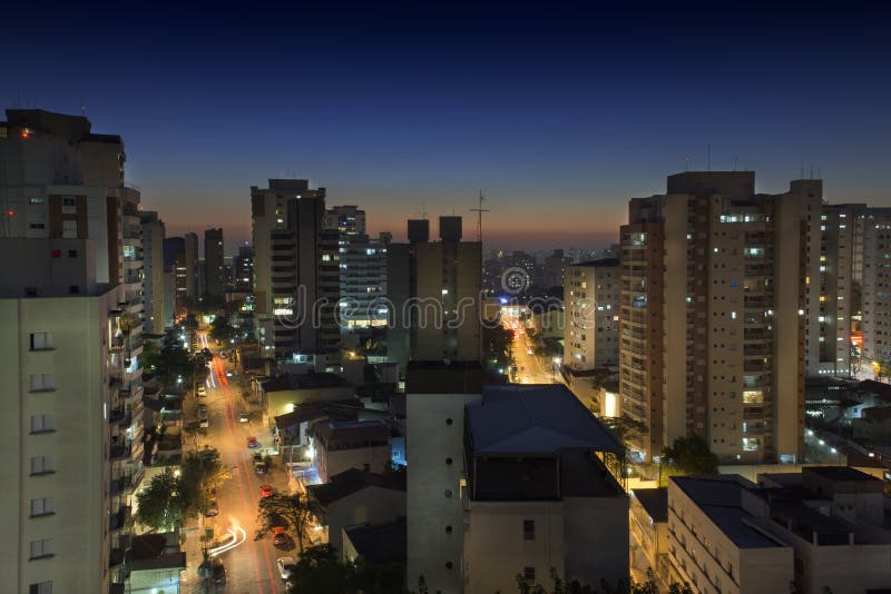 Sao Paulo is a megalopolis, with a metro area population of 20 million people. The cities landscape is overwhelmingly filled with highrise buildings. This is a typical neighborhood in Zona Sul by night. Sao Paulo is a megalopolis, with a metro area population of 20 million people. The cities landscape is overwhelmingly filled with highrise buildings. This is a typical neighborhood in Zona Sul by night.