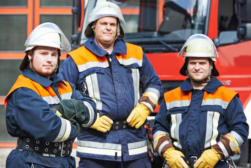 Firefighter in uniform in front of fire engine machine and fireman team. Firefighter in uniform in front of fire engine machine and fireman team.