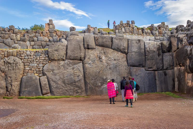 Tourists Visiting Largest Inca Masonry Rock in the Wall at the Saqsaywaman Fortress outside Cuzco. Tourists Visiting Largest Inca Masonry Rock in the Wall at the Saqsaywaman Fortress outside Cuzco