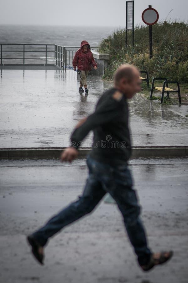 Man walking in the rain editorial stock photo. Image of rainfall - 99397128