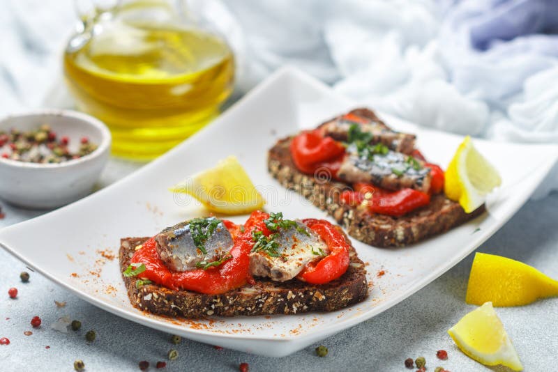 Sardine sandwiches and baked bell peppers on rye bread