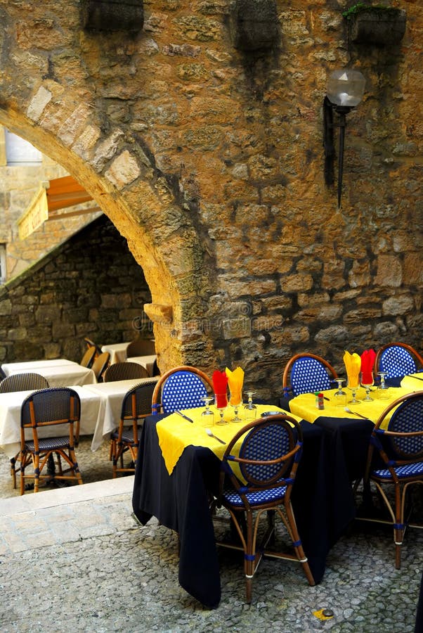 Restaurant patio among medieval walls in Sarlat, Dordogne region, France. Restaurant patio among medieval walls in Sarlat, Dordogne region, France