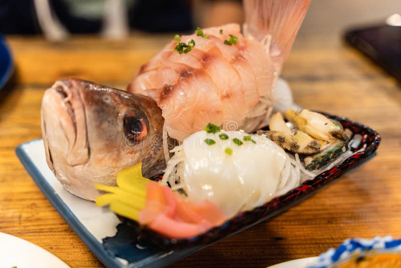 Sashimi of Sea Bass Fillet, Fresh Squid and Shell on Ceramic Plate