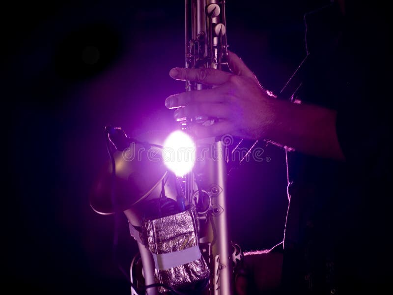 Detail of a saxophone being played live on stage. Detail of a saxophone being played live on stage