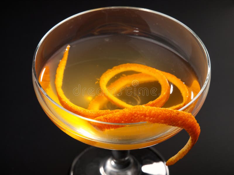 Satan Whiskers cocktail isolated on black background. Made from 1 oz gin, 1/2 oz orange liqueur, 1 oz dry vermouth, 1 oz sweet vermouth, 1 oz orange juice, 2 dashes orange bitters. Satan Whiskers cocktail isolated on black background. Made from 1 oz gin, 1/2 oz orange liqueur, 1 oz dry vermouth, 1 oz sweet vermouth, 1 oz orange juice, 2 dashes orange bitters