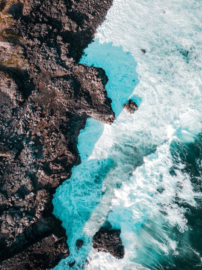 Aerial view of Pont Naturel Mauritius. Natural stone bridge, atraction of southern coastline in Mauritius. Amazing clear blue water on high ocean waves. Aerial view of Pont Naturel Mauritius. Natural stone bridge, atraction of southern coastline in Mauritius. Amazing clear blue water on high ocean waves.