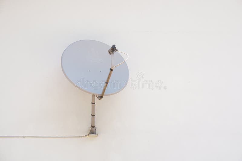 Satellite dish attached to the wall of the house