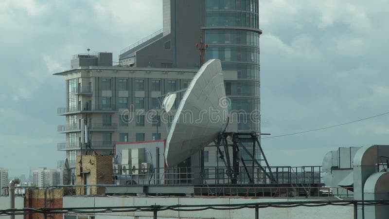 Satellite dish on the roof on the building background, decrease. Decrease video