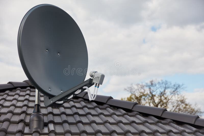 Satellite Dish on the Roof of the House for Satellite Reception Stock