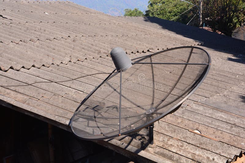 Satellite dish or TV transmitter antennas on roof of the house, note select focus with shallow depth of field