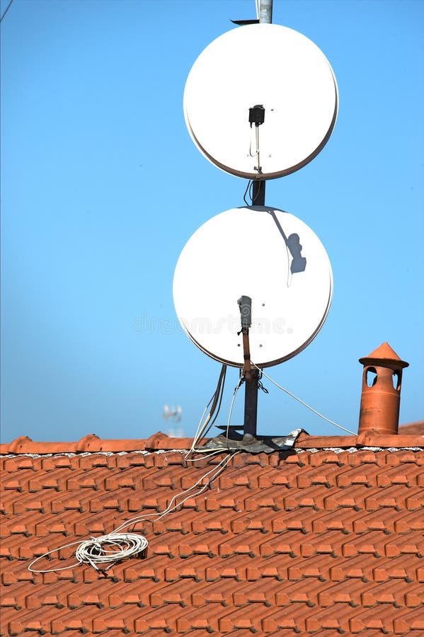 Satellite Dishes on a Tiled Roof Stock Photo Image of