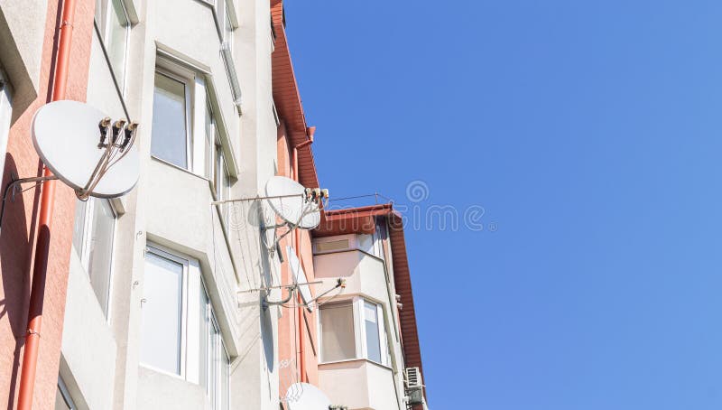 Satellite tv dish antenna on house wall royalty free stock image
