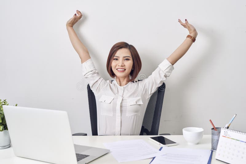 Satisfied woman relaxing with hands behind her head. Happy smiling employee after finish work, reading good news, break at work