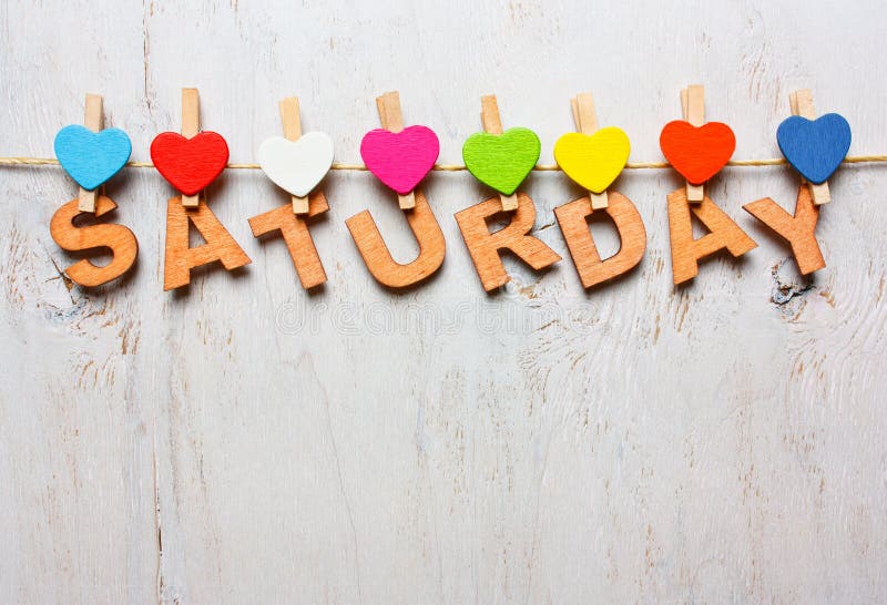 Saturday word from wooden letters on a white wooden background