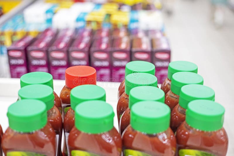 Sauces and condiments wrapped in plastic lids in a supermarket. royalty free stock photos