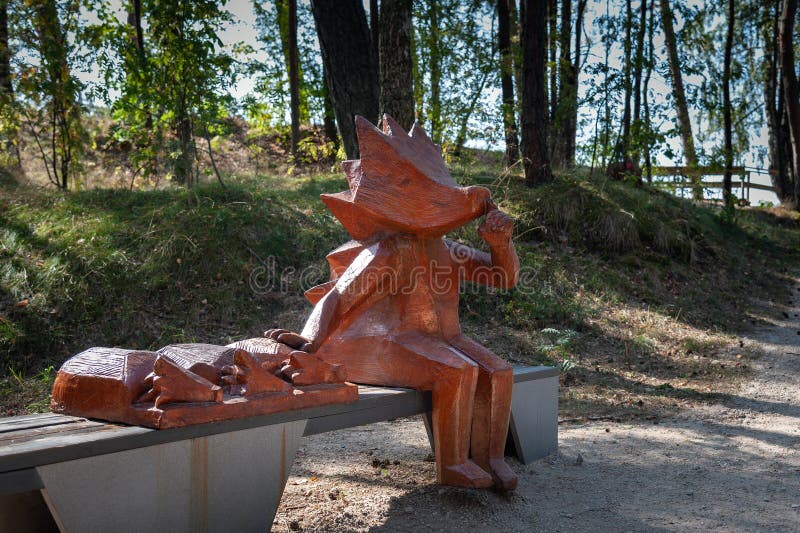 Figure of wooden hedgehog is sitting on a bench royalty free stock images Figure of wooden hedgehog is sitting on a bench royalty free stock images