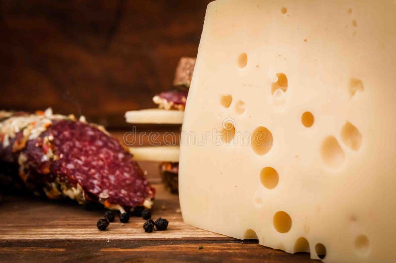 Dried sausage and cheese with holes for breakfast stock images Dried sausage and cheese with holes for breakfast stock images