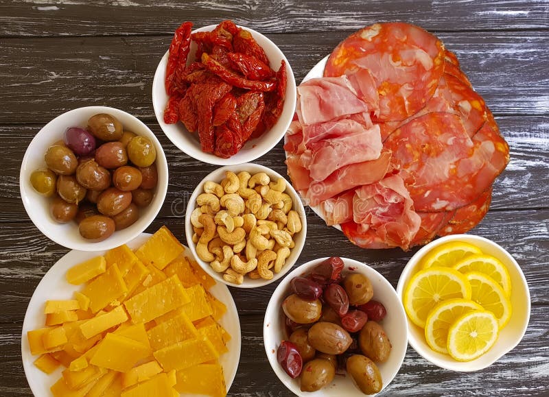 Sausage cheese jamon collection olives cashew nuts on wooden background stock image Sausage cheese jamon collection olives cashew nuts on wooden background stock image