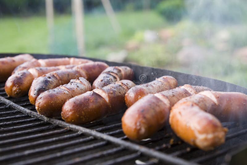 A lot of sausages on a grill