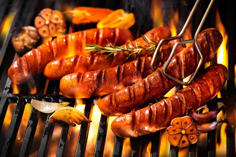 Sausages on the barbecue grill with flames royalty free stock photo Sausages on the barbecue grill with flames royalty free stock photo
