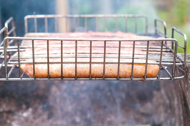 Sausages on the Grill Rack Fried on Charcoal. Side View. Stock Image
