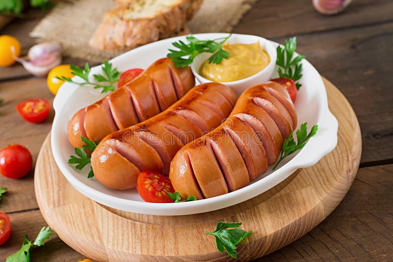 Sausages on the grill with vegetables.