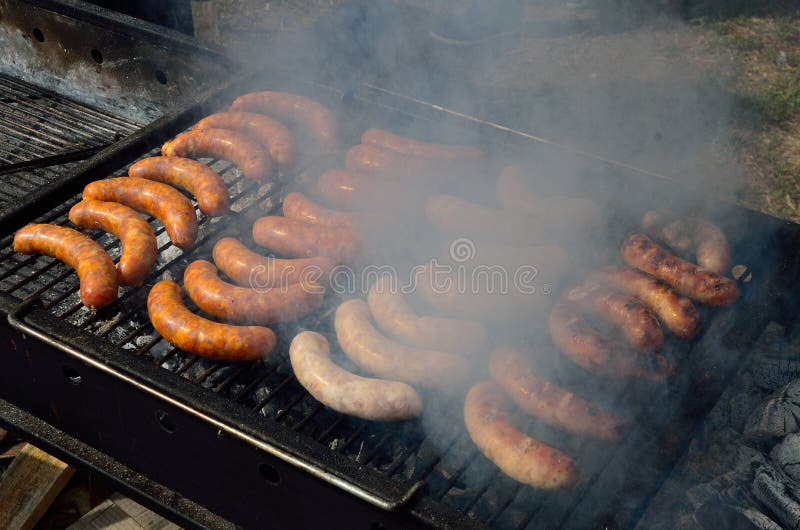 Sausages on the Hot Grill with Smoke Stock Photo Image of cooked