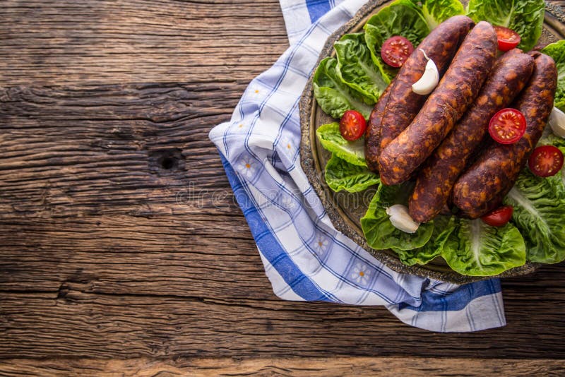 Sausages. Smoked Sausages. Chorizo sausages with vegetable rosemary spices and kitchen utensil