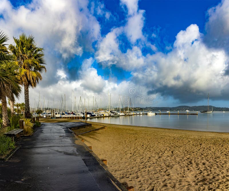 Sausalito beach under white clouds and blue sky in the San Francisco Bay area in Marin county in the state of California.