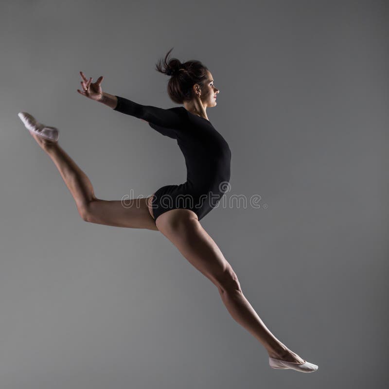 Girl wearing sport body and pointe shoes is jumping in dance. Girl wearing sport body and pointe shoes is jumping in dance