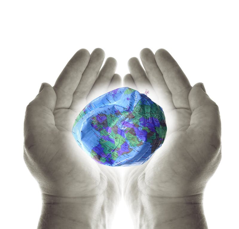 Hands holding deflated earth globe. the world being nutured or exploited. Hands holding deflated earth globe. the world being nutured or exploited