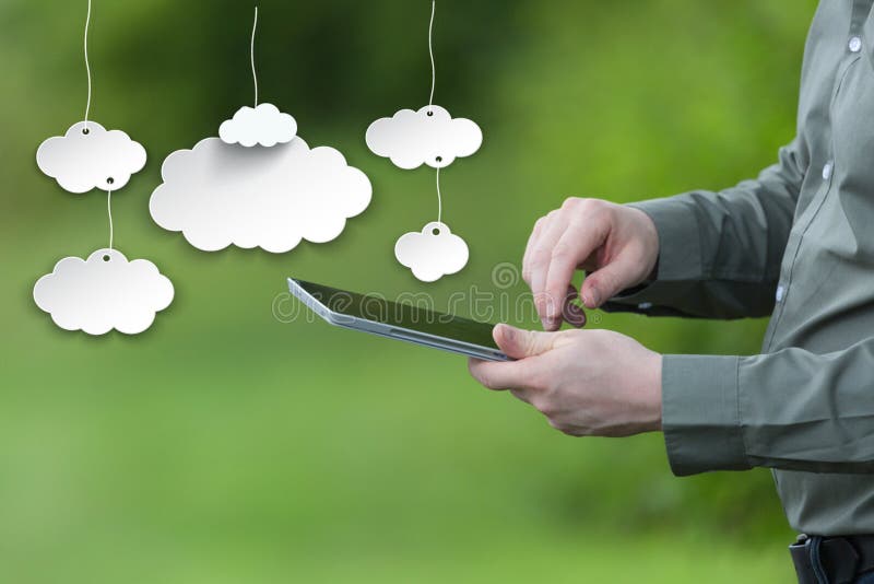 Saving data on the cloud concept. Businessman holding a smart tablet, mobile green background stock image Saving data on the cloud concept. Businessman holding a smart tablet, mobile green background stock image