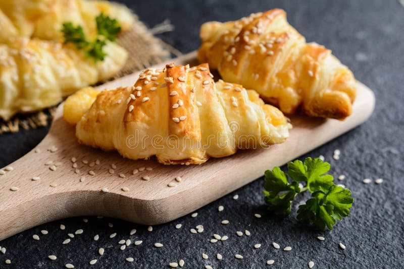 Savory croissants stuffed with Emmental cheese stock photo Savory croissants stuffed with Emmental cheese stock photo