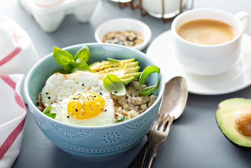 Savory oatmeal with sunny side up egg and avocado for breakfast. Savory oatmeal with sunny side up egg and avocado for breakfast