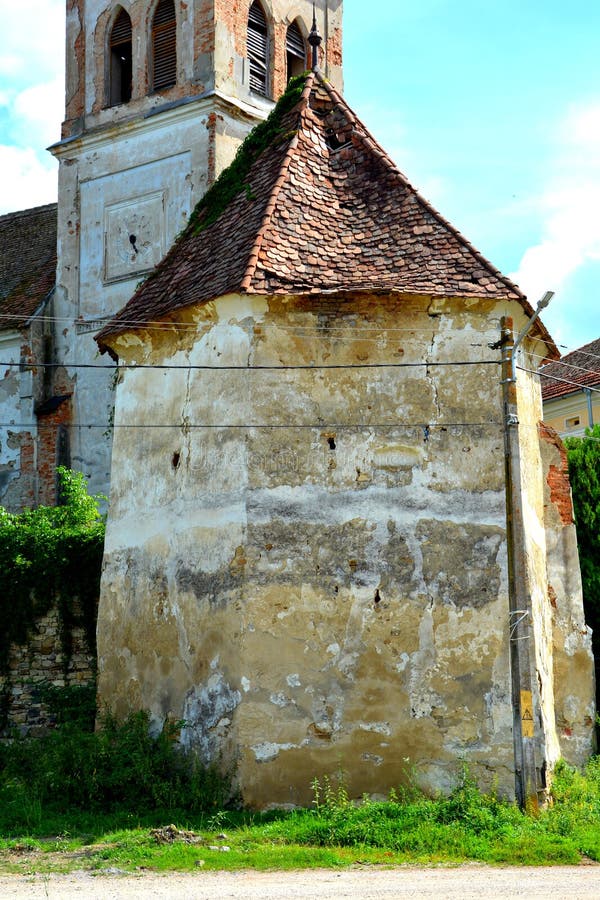 Saxon medieval lutheran church . Typical rural landscape and peasant houses in the village Beia, Transylvania, Romania.