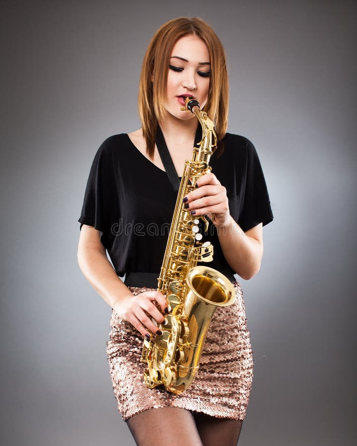 Woman with saxophone. stock image. Image of white, play 17925491