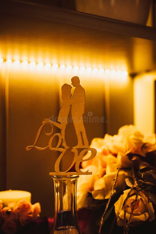 Say yes,wedding figurines holding hands. wooden cake topper with word love.Toned image.figure of a couple in love.happy royalty free stock photo Say yes,wedding figurines holding hands. wooden cake topper with word love.Toned image.figure of a couple in love.happy royalty free stock photo