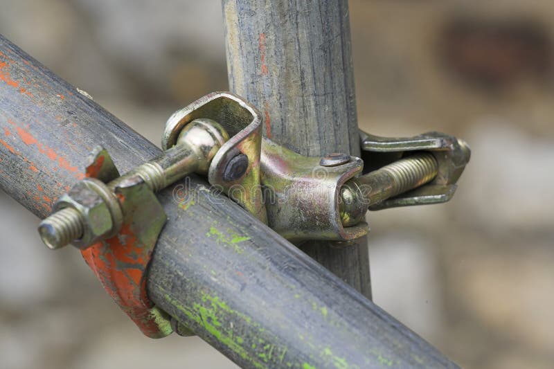 Two scaffolding pipes joined together with a swivel connector. Two scaffolding pipes joined together with a swivel connector.