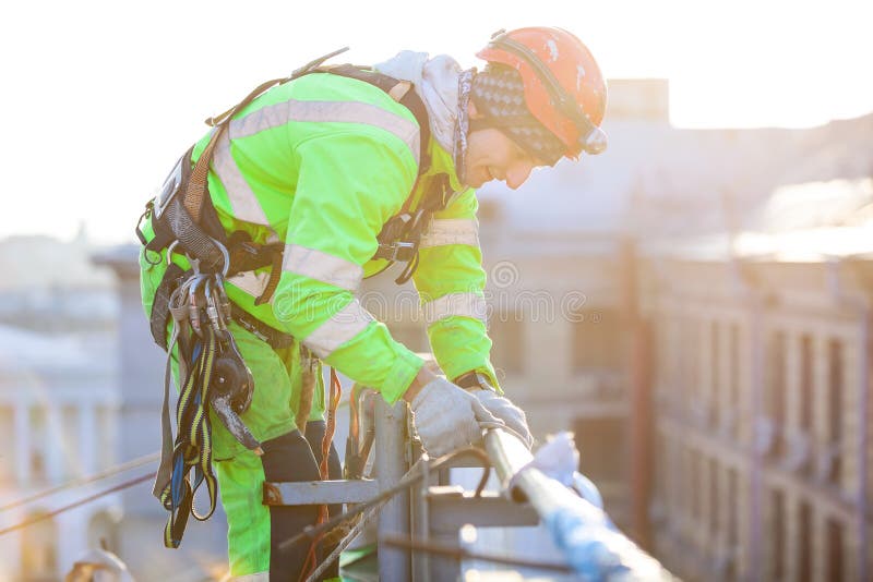 Young caucasian industrial climber on a roof of a building. Young caucasian industrial climber on a roof of a building