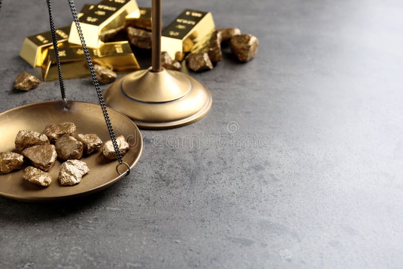 Scale pan with gold lumps on grey table. royalty free stock images Scale pan with gold lumps on grey table. royalty free stock images